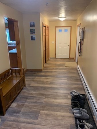 87 Oxford Road Charlton, MA 01507 - Photo 7 of 22 a hallway with front door and wooden floor
