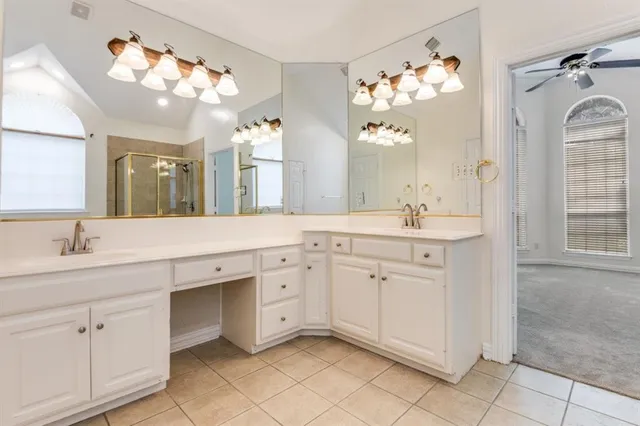 a bathroom with a tub a sink and mirror