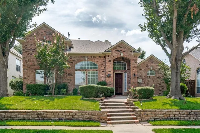 a wooden bench sitting in front of a building