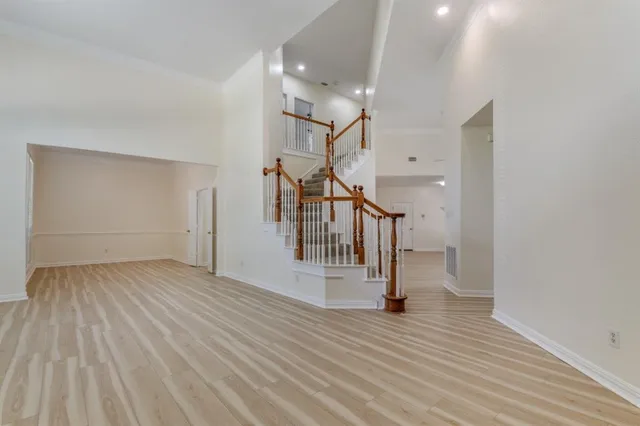 a view of entryway and hall with wooden floor