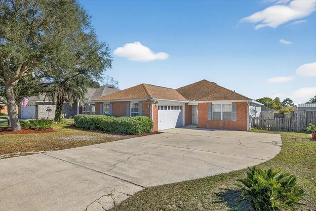 a front view of a house with yard and trees
