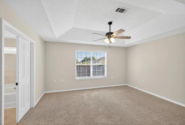 an aerial view of a house with a yard and lake view