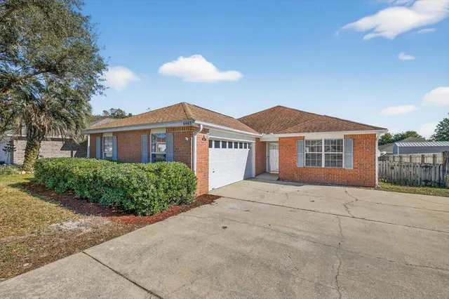 a view of an empty room with a ceiling fan