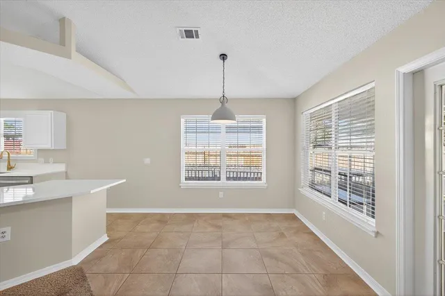 a view of a room with a ceiling fan and a window