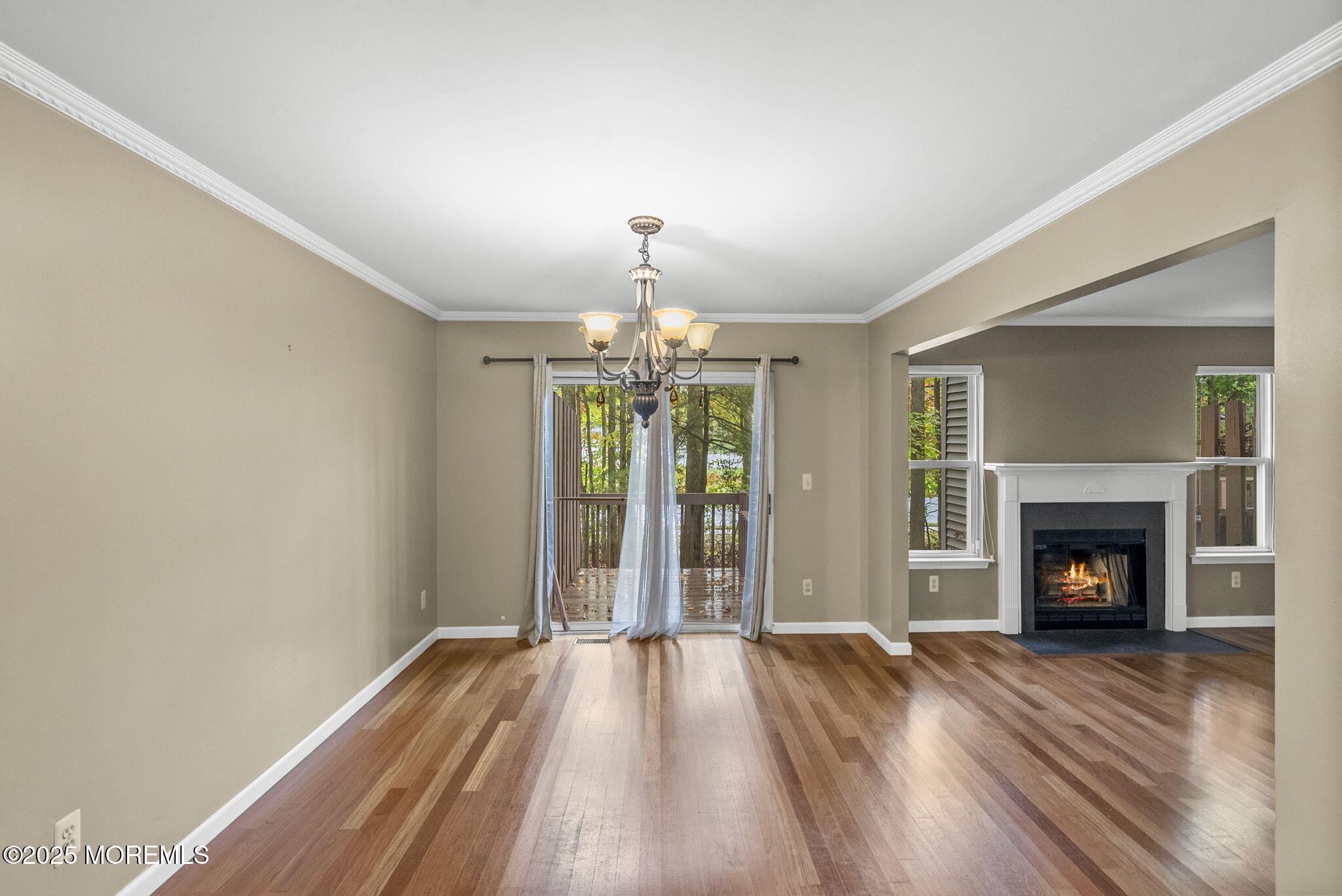 63 Atrium Way, Unit 63 Manalapan, NJ 07726 - Photo 12 of 40 a view of an empty room with wooden floor fireplace and a window
