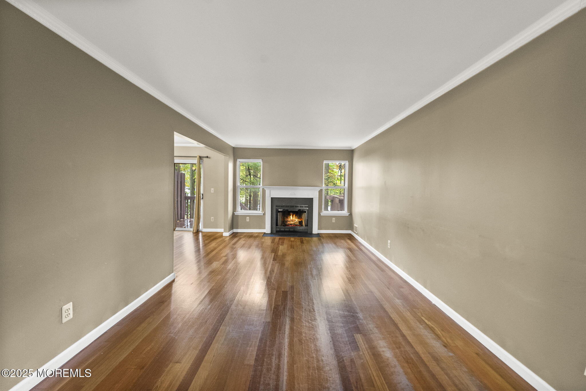 63 Atrium Way, Unit 63 Manalapan, NJ 07726 - Photo 15 of 40 a view of an empty room with wooden floor and a window