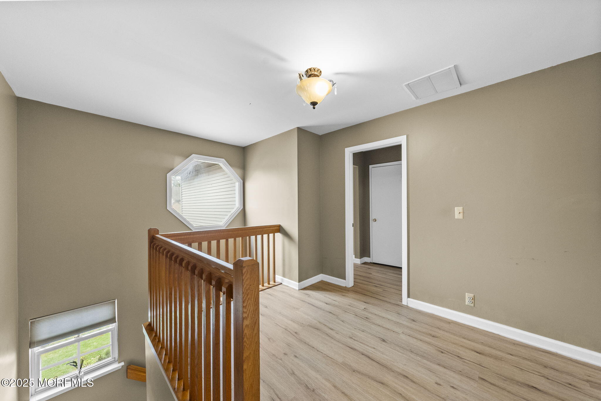 63 Atrium Way, Unit 63 Manalapan, NJ 07726 - Photo 19 of 40 a view of a hallway with wooden floor