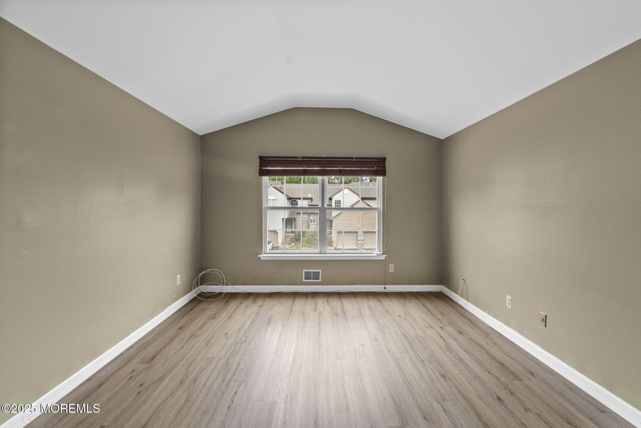63 Atrium Way, Unit 63 Manalapan, NJ 07726 - Photo 21 of 40 an empty room with wooden floor and windows