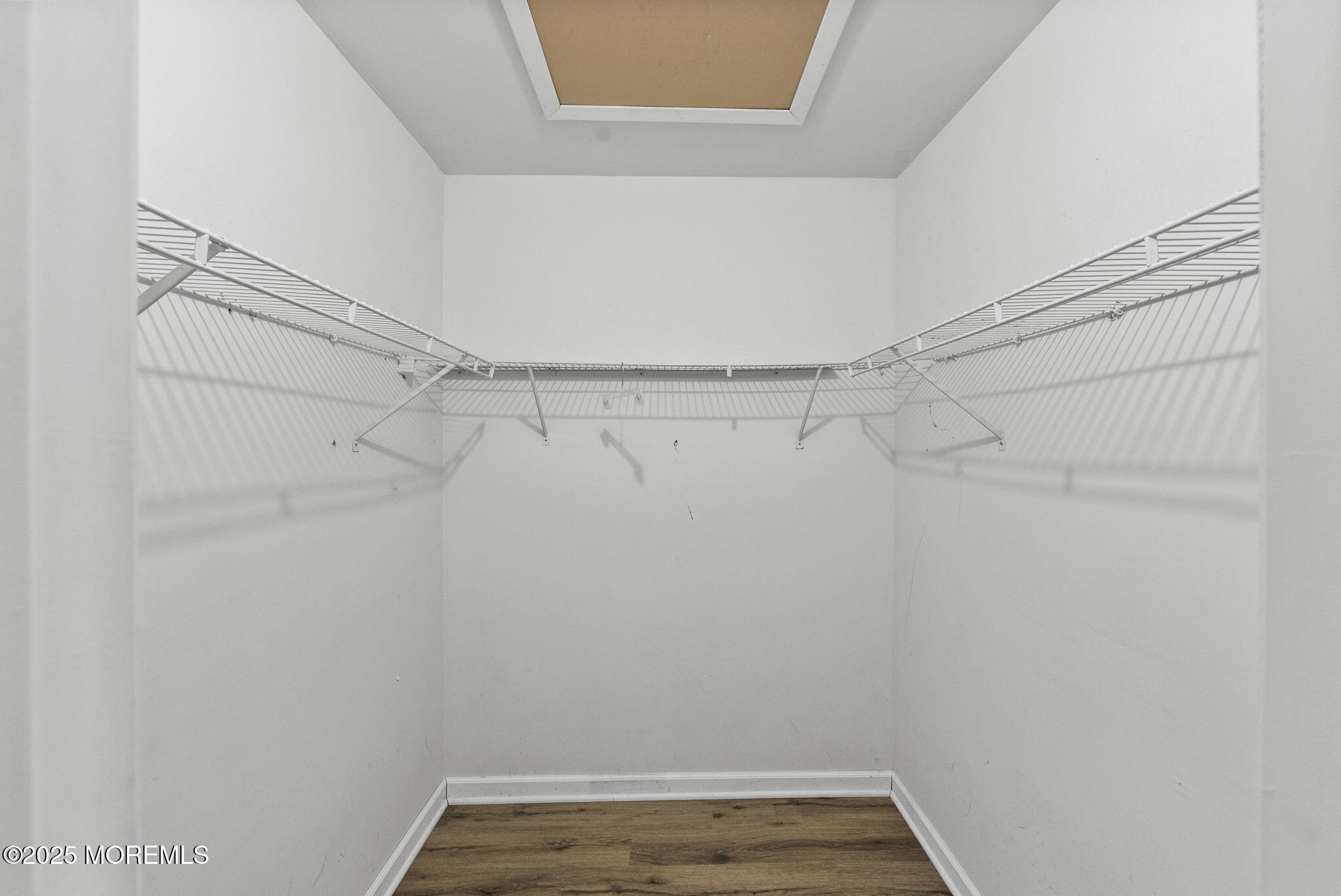 63 Atrium Way, Unit 63 Manalapan, NJ 07726 - Photo 24 of 40 a view of a room with racks on the wall