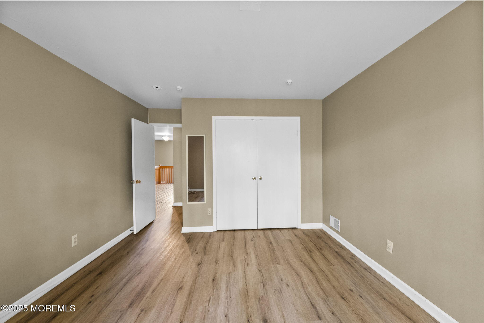 63 Atrium Way, Unit 63 Manalapan, NJ 07726 - Photo 29 of 40 a view of empty room with wooden floor