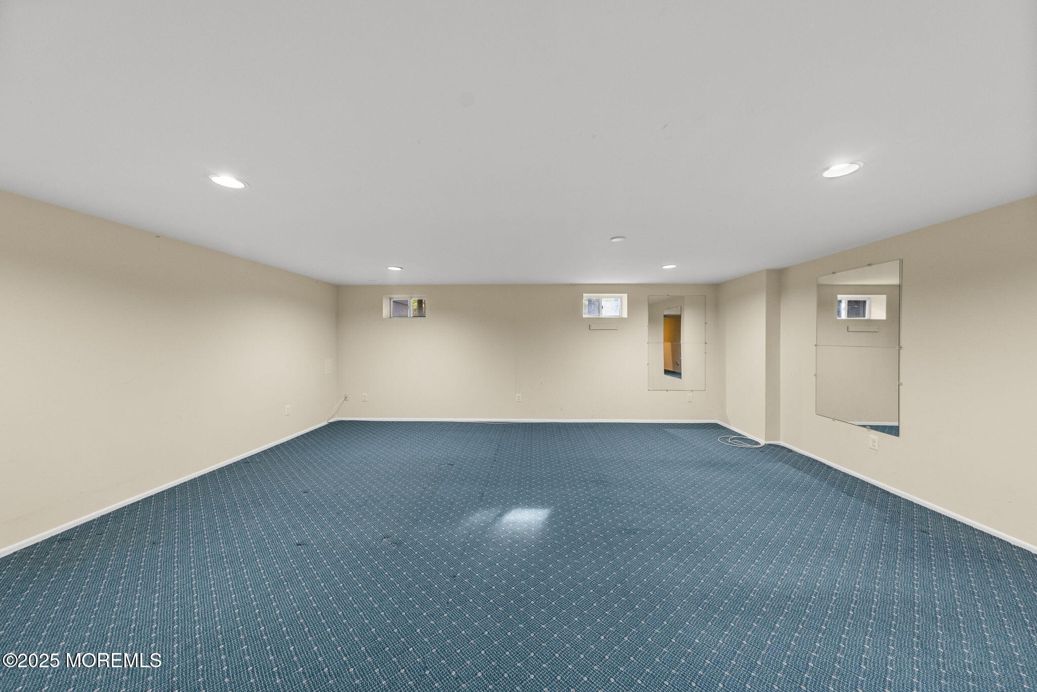 63 Atrium Way, Unit 63 Manalapan, NJ 07726 - Photo 33 of 40 an empty room with windows and entrance to other room