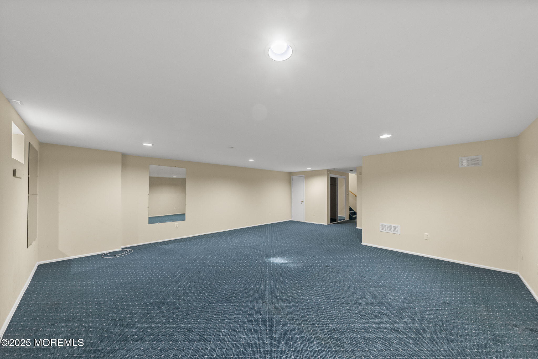 63 Atrium Way, Unit 63 Manalapan, NJ 07726 - Photo 34 of 40 an empty room with a empty space and windows