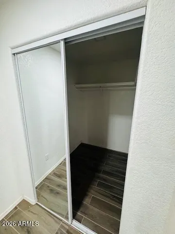a bathroom with a granite countertop sink a toilet and a shower