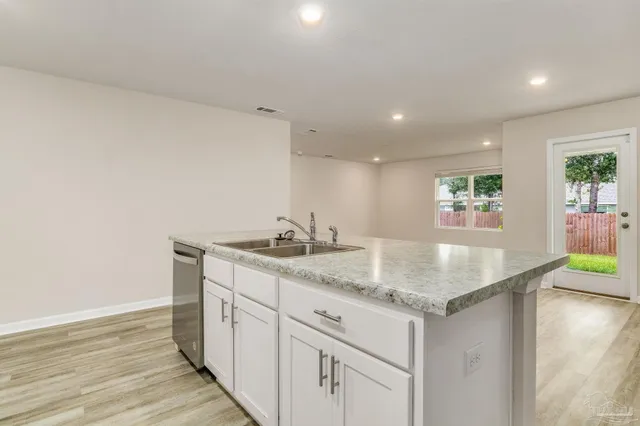 a kitchen with sink and mirror