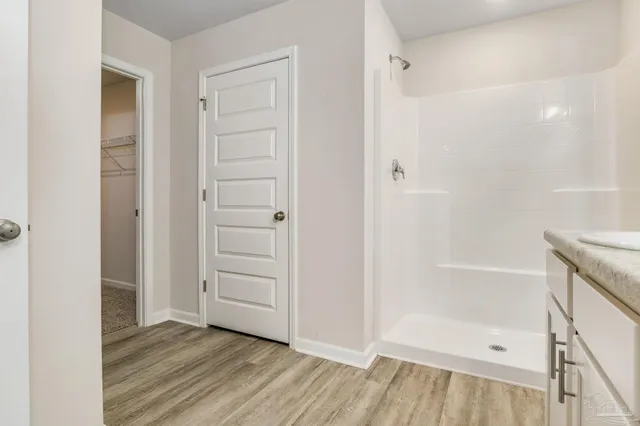 an empty room with wooden floor and closet