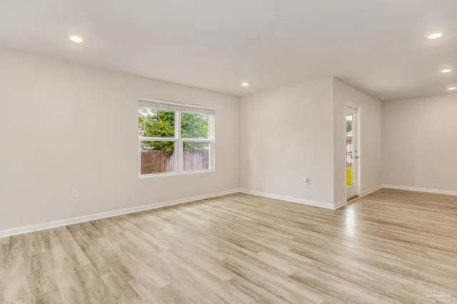 a view of a backyard with wooden fence