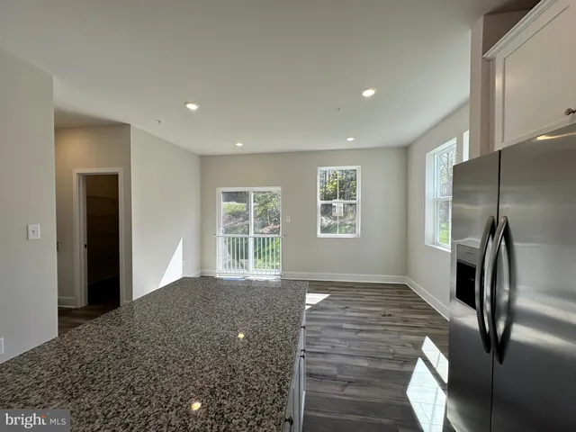 a large kitchen with stainless steel appliances granite countertop a large counter top and a stove top oven