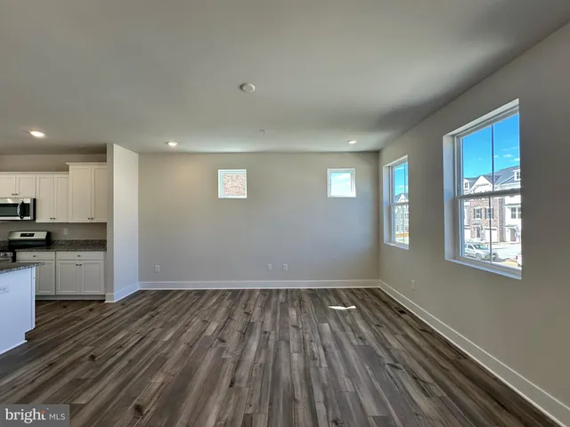 a kitchen with stainless steel appliances granite countertop a sink refrigerator and microwave