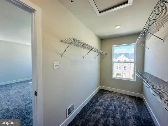 a view of staircase with lots of frames on wall and wooden floor