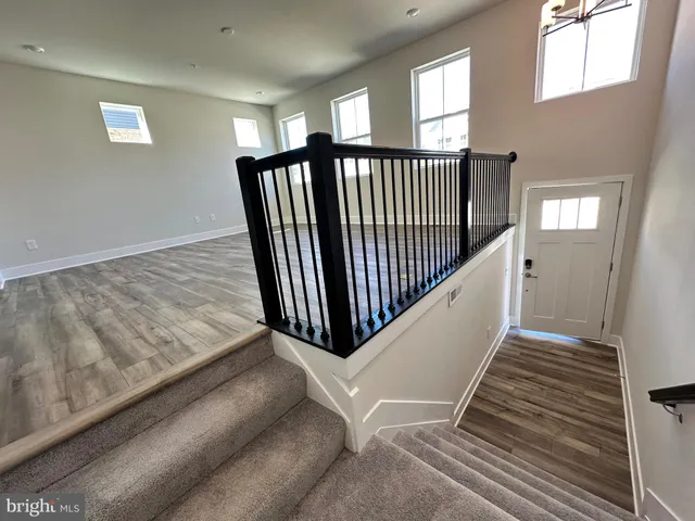 a view of a big room with wooden floor and windows