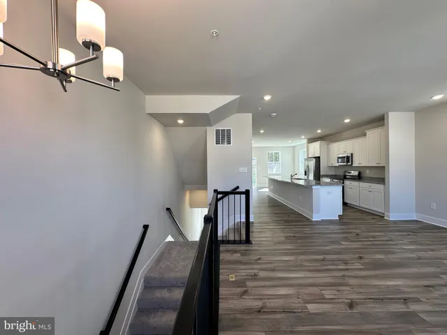 a bathroom with a granite countertop sink and washing machine