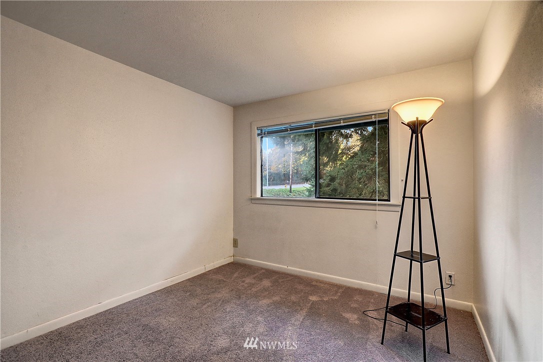4404 Terrace Drive, Unit 3 Everett, WA 98203 - Photo 7 of 18 a view of an empty room with wooden floor and a window
