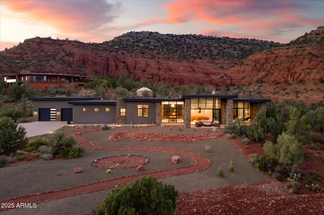 a view of a house with a yard and mountain view in back