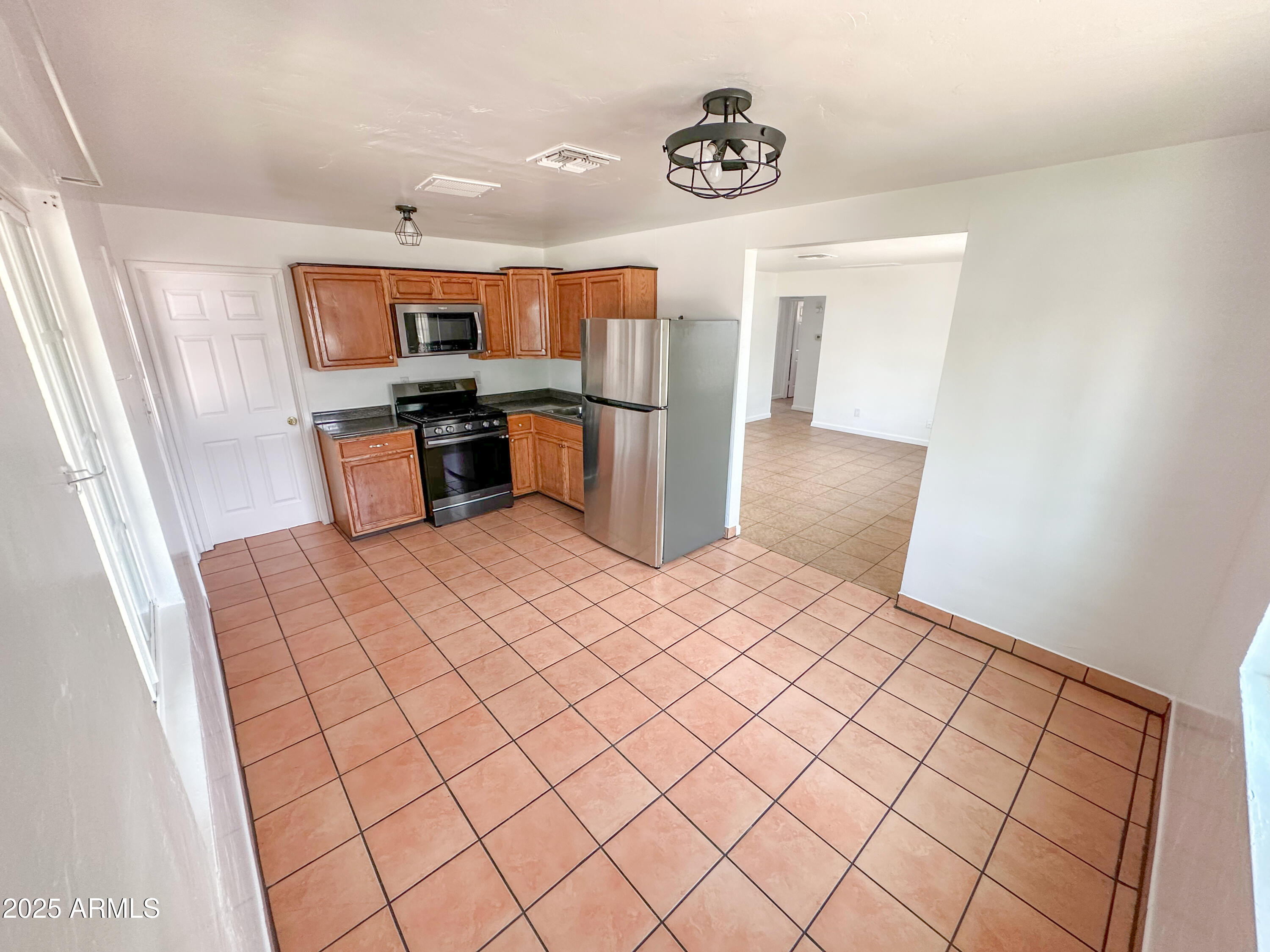 2928 North 37th Avenue Phoenix, AZ 85019 - Photo 3 of 13 a room with a bed and a television