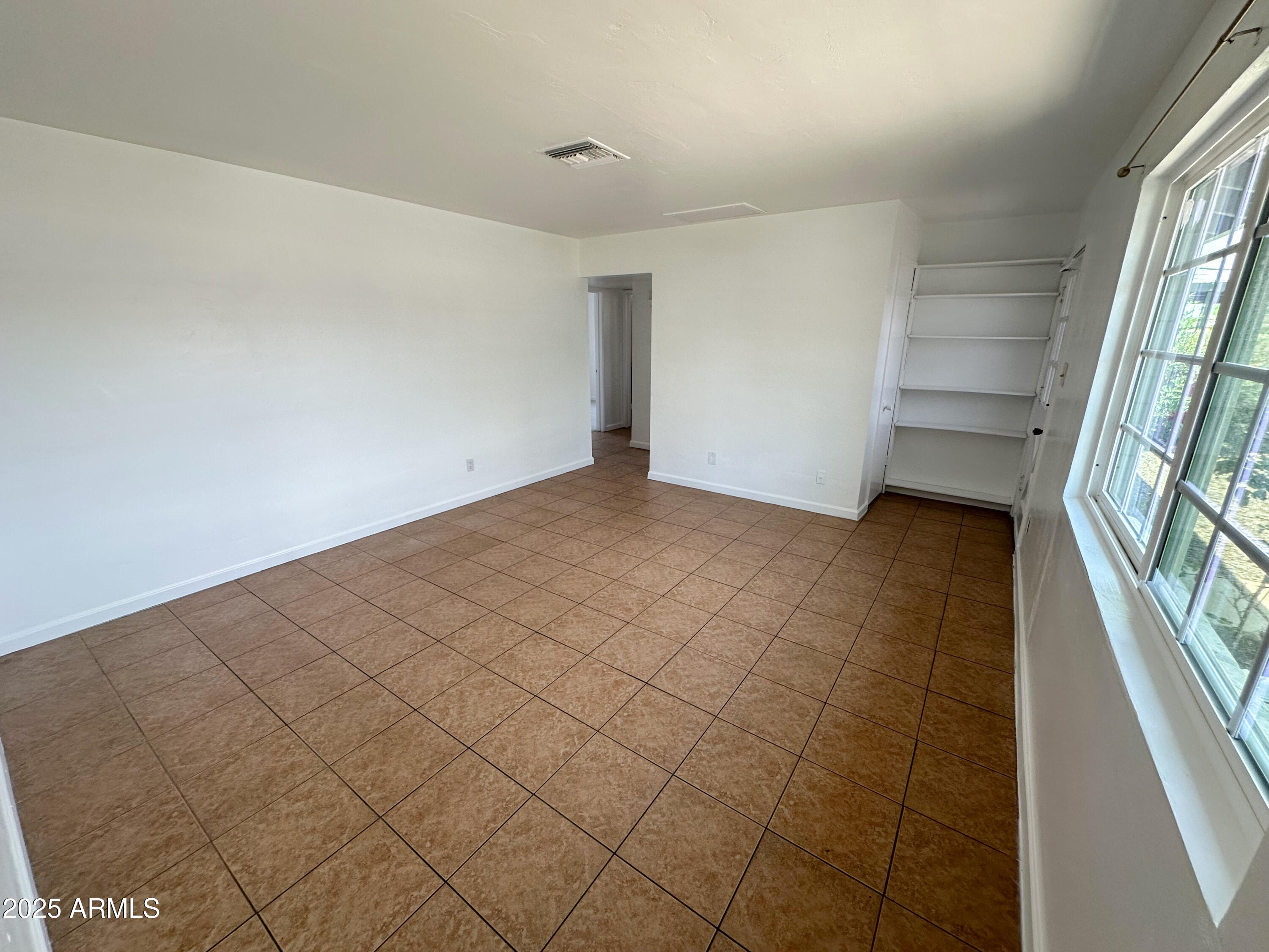 2928 North 37th Avenue Phoenix, AZ 85019 - Photo 4 of 13 wooden floor in an empty room with a window