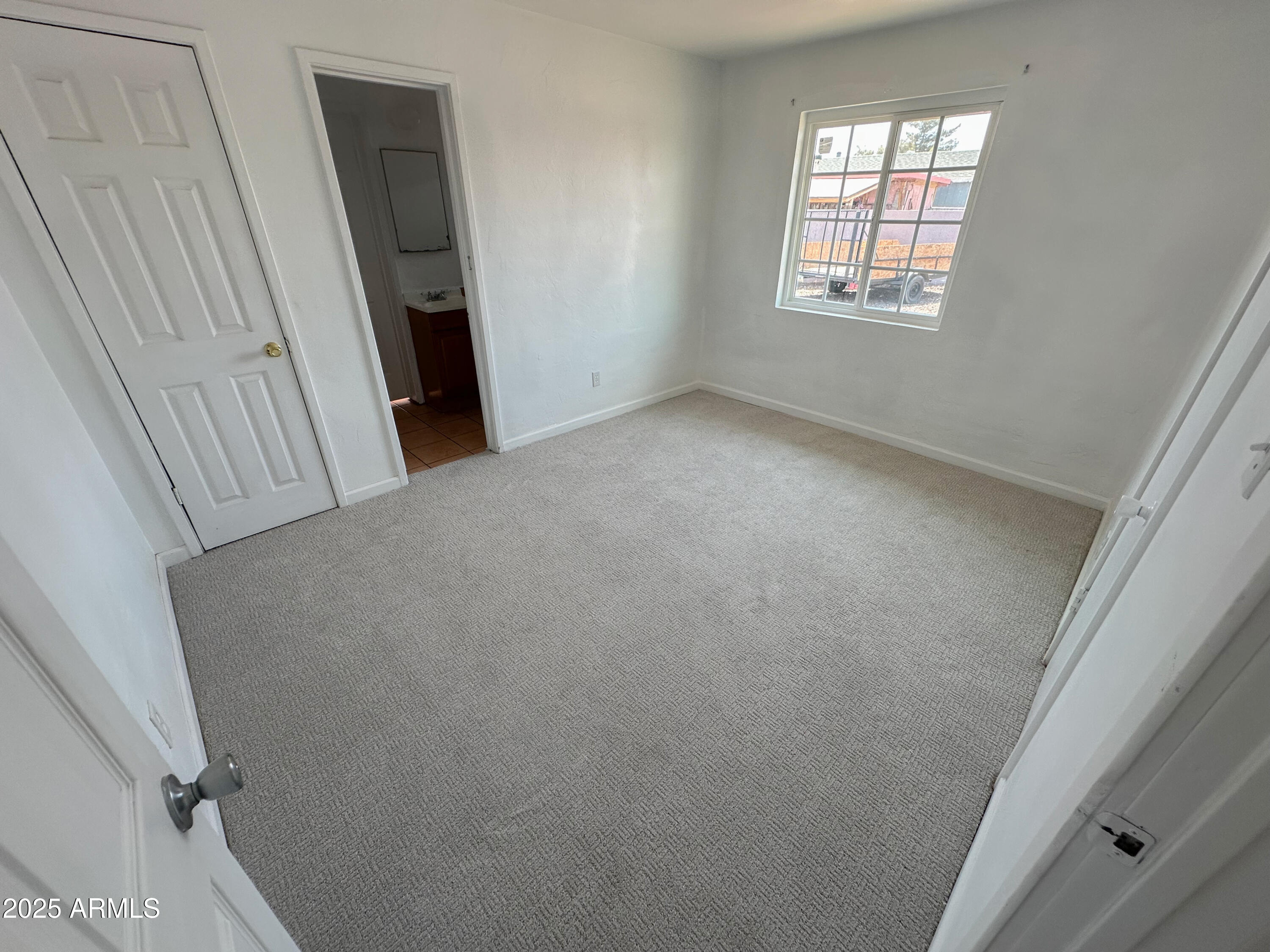 2928 North 37th Avenue Phoenix, AZ 85019 - Photo 7 of 13 an empty room with windows
