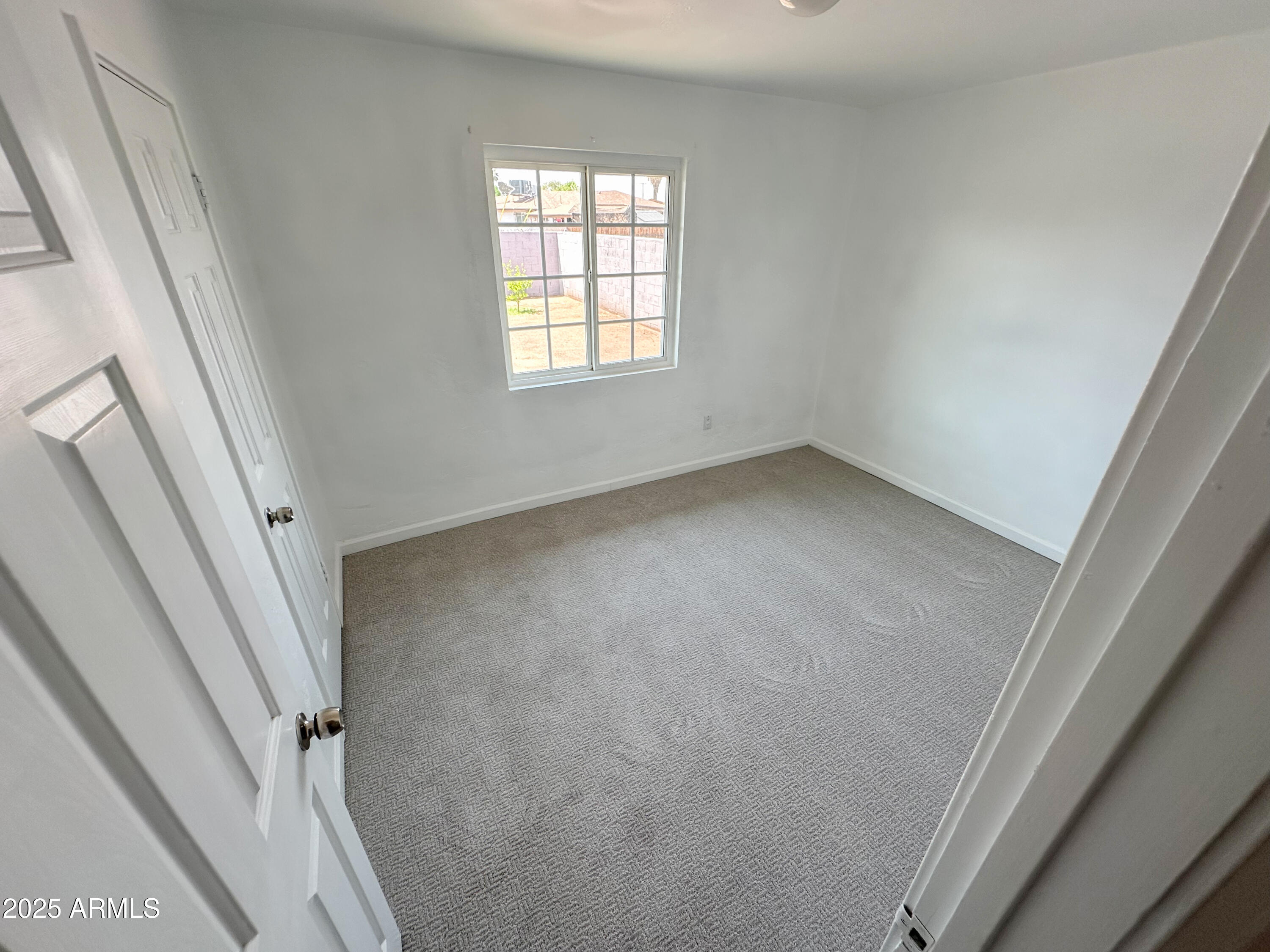 2928 North 37th Avenue Phoenix, AZ 85019 - Photo 8 of 13 a view of an empty room with a window