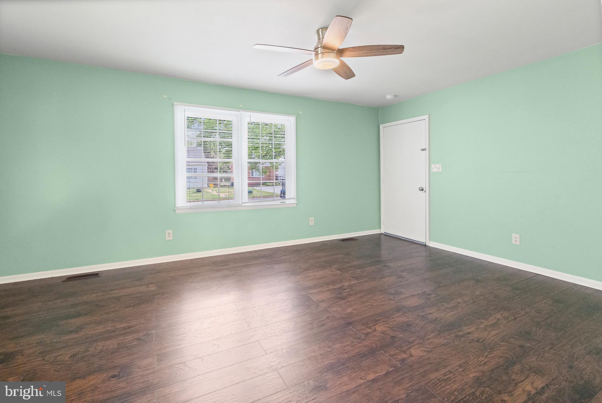 6 Cinder Road Lutherville-Timonium, MD 21093 - Photo 12 of 41 a view of an empty room with wooden floor and a window