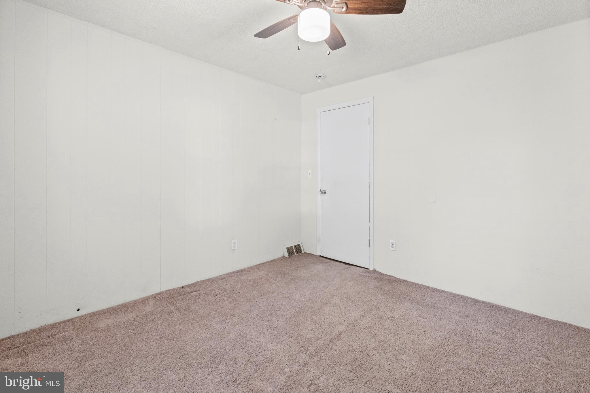 6 Cinder Road Lutherville-Timonium, MD 21093 - Photo 19 of 41 an empty room with a ceiling fan and carpet