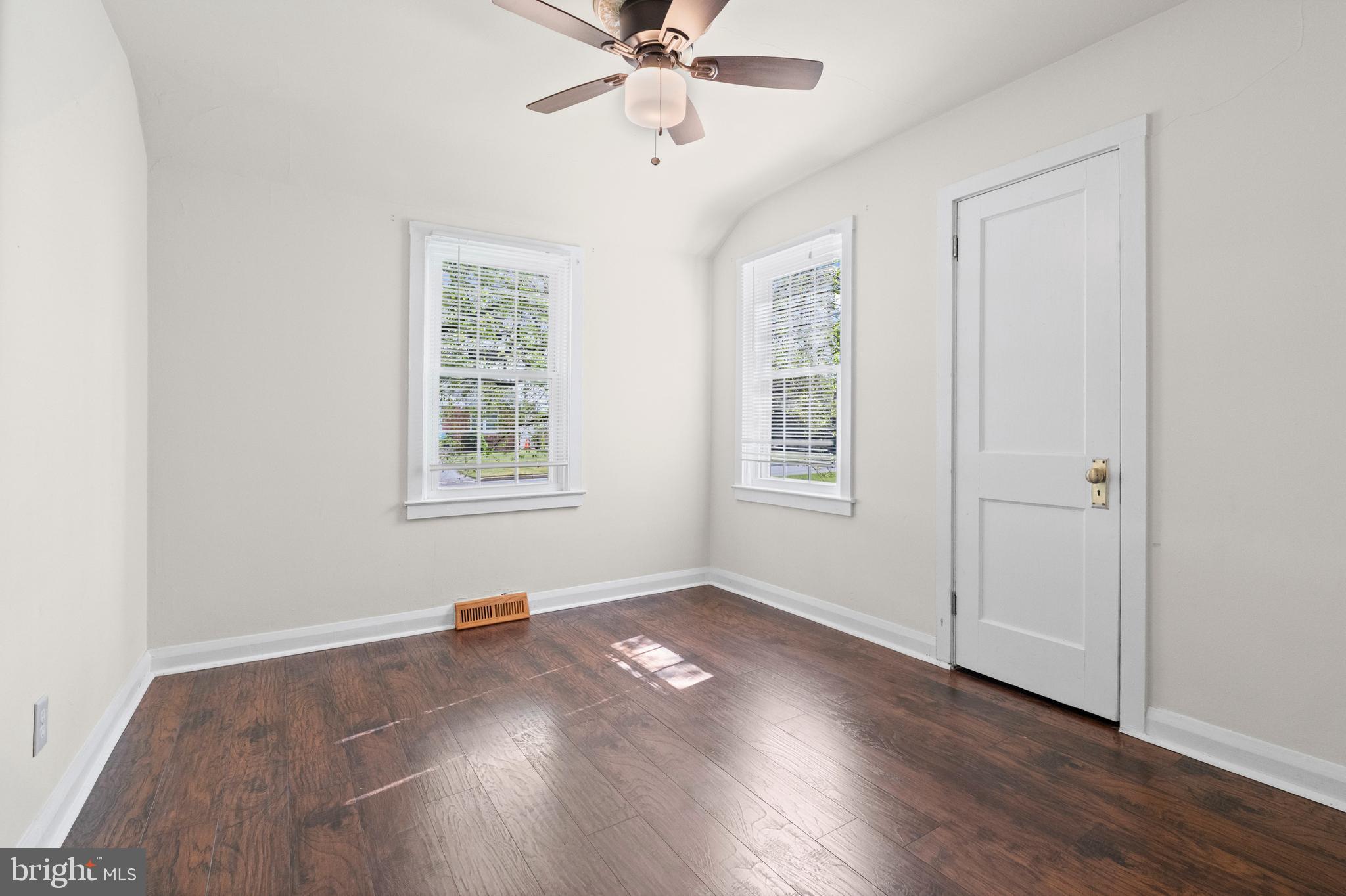 6 Cinder Road Lutherville-Timonium, MD 21093 - Photo 20 of 41 an empty room with wooden floor chandelier fan and windows