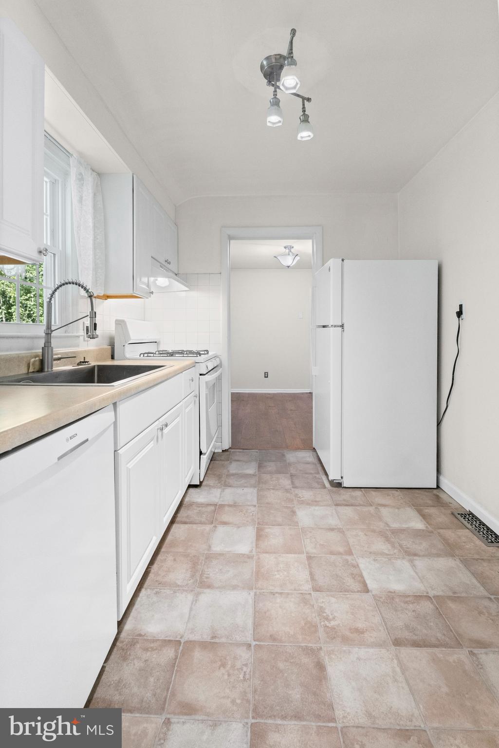 6 Cinder Road Lutherville-Timonium, MD 21093 - Photo 5 of 41 a large white kitchen with a sink and dishwasher