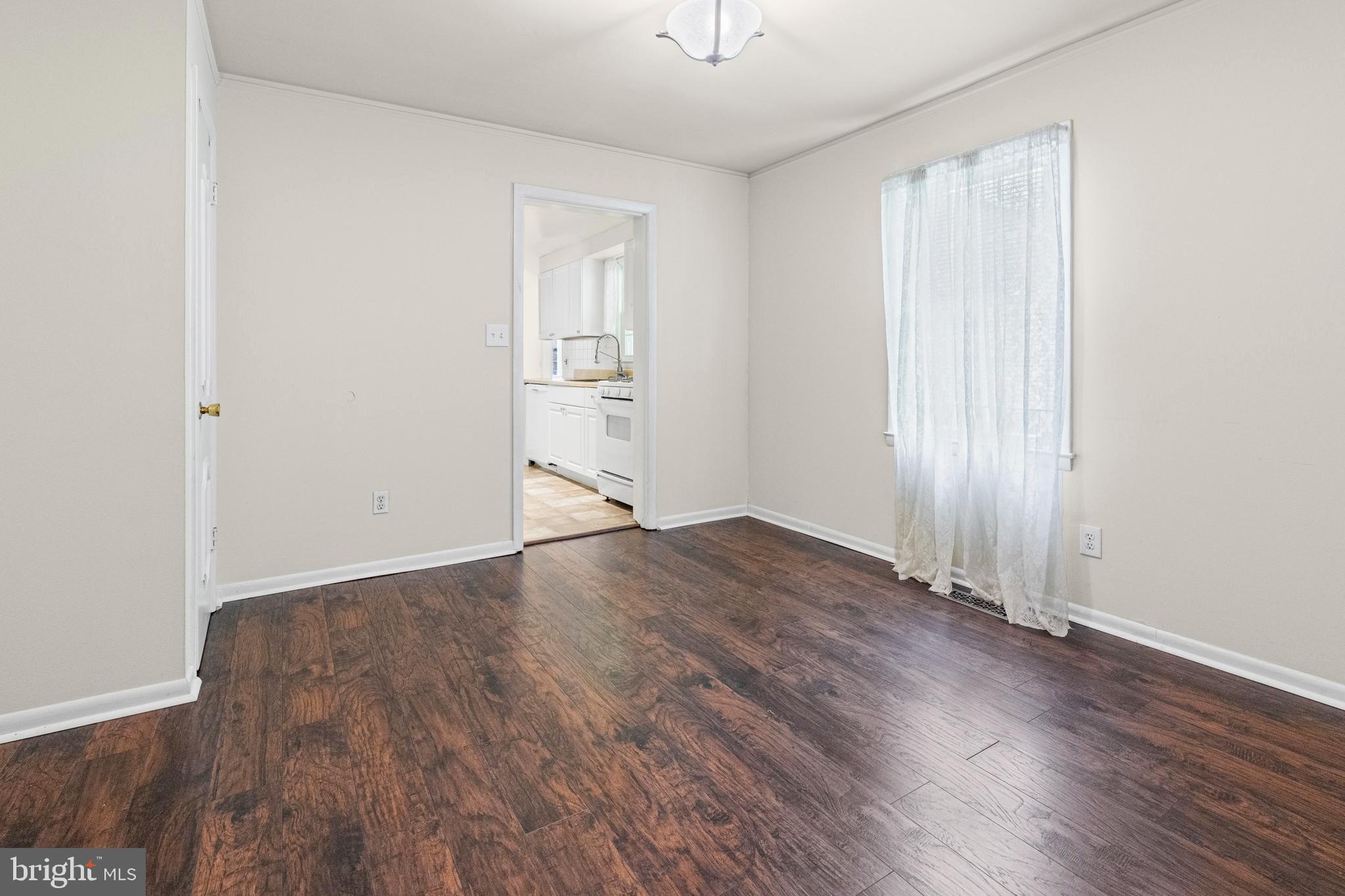 6 Cinder Road Lutherville-Timonium, MD 21093 - Photo 7 of 41 an empty room with wooden floor cabinet and windows