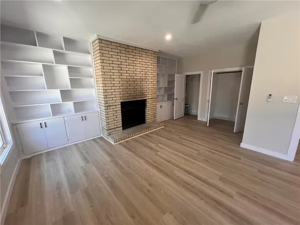 wooden floor in an empty room with a fireplace