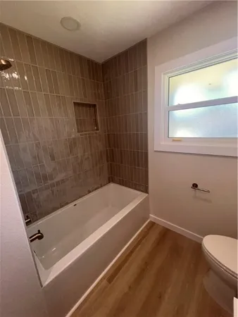 a bathroom with a tub and a shower