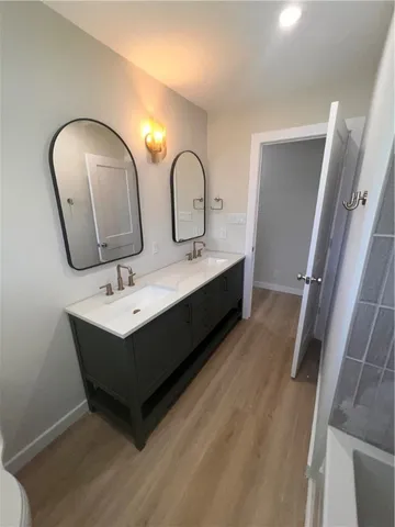 a bathroom with 2 sink and a mirror