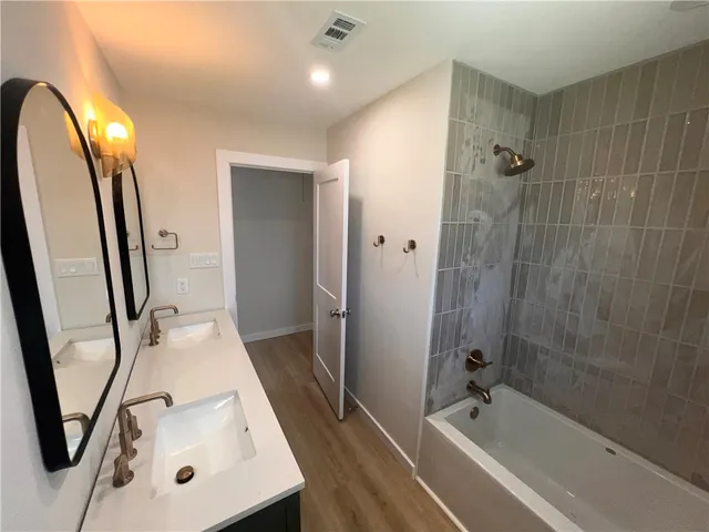 a bathroom with a sink a mirror and shower