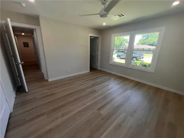 wooden floor in an empty room with a window