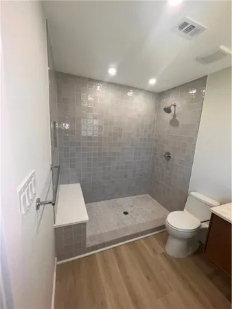 a bathroom with a shower and a toilet