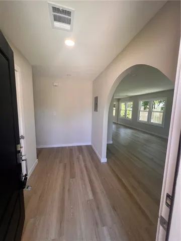 wooden floor in an empty room with a mirror