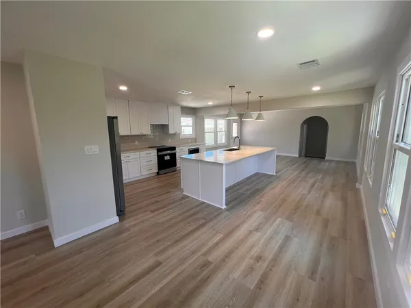a view of kitchen and closet with wooden floor