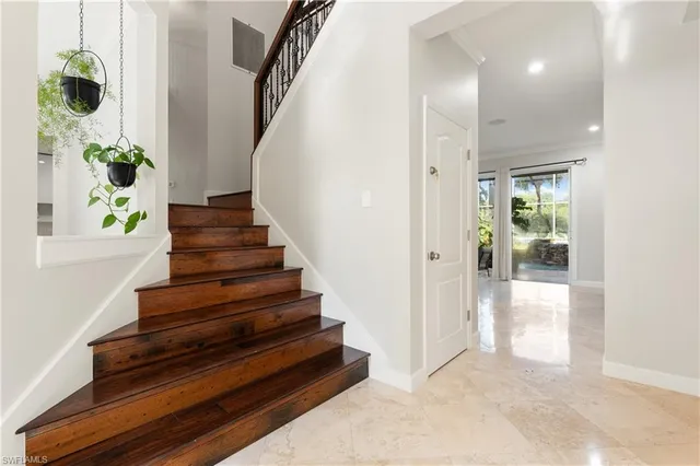 a view of entryway and hall with wooden floor