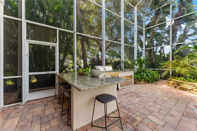 a view of a patio with table and chairs and potted plants