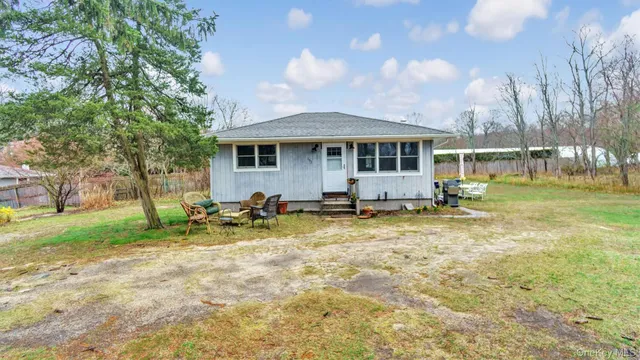 a view of a house with a patio and a fire pit