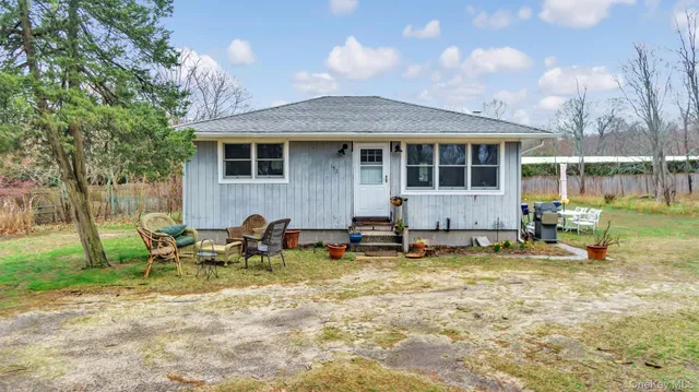 a view of a house with backyard porch and sitting area