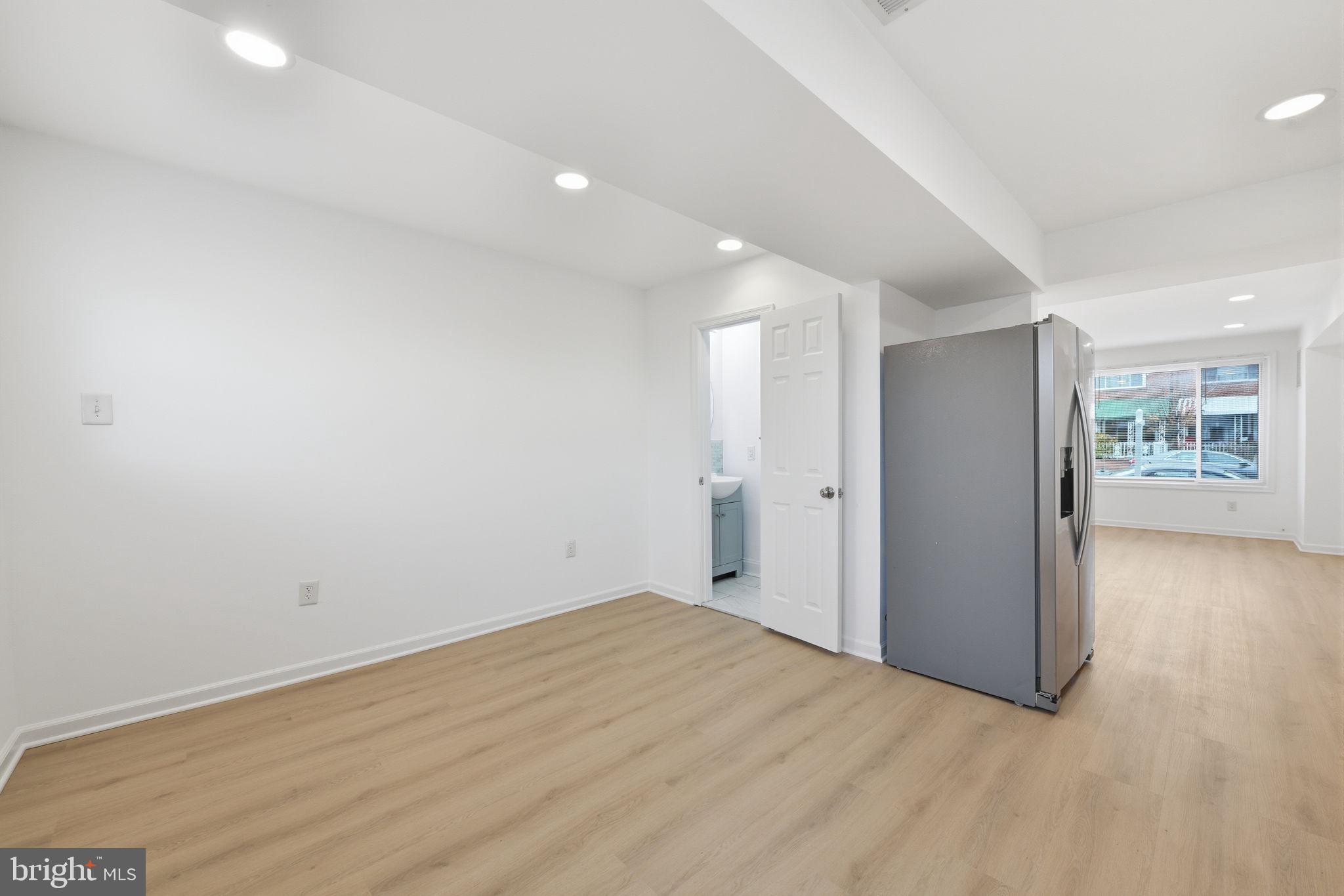 2242 16th Street Northeast Washington, DC 20018 - Photo 11 of 41 a view of an empty room with wooden floor and a window