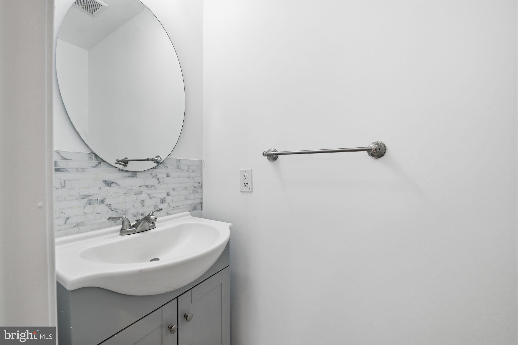 2242 16th Street Northeast Washington, DC 20018 - Photo 16 of 41 a bathroom with a sink and a mirror